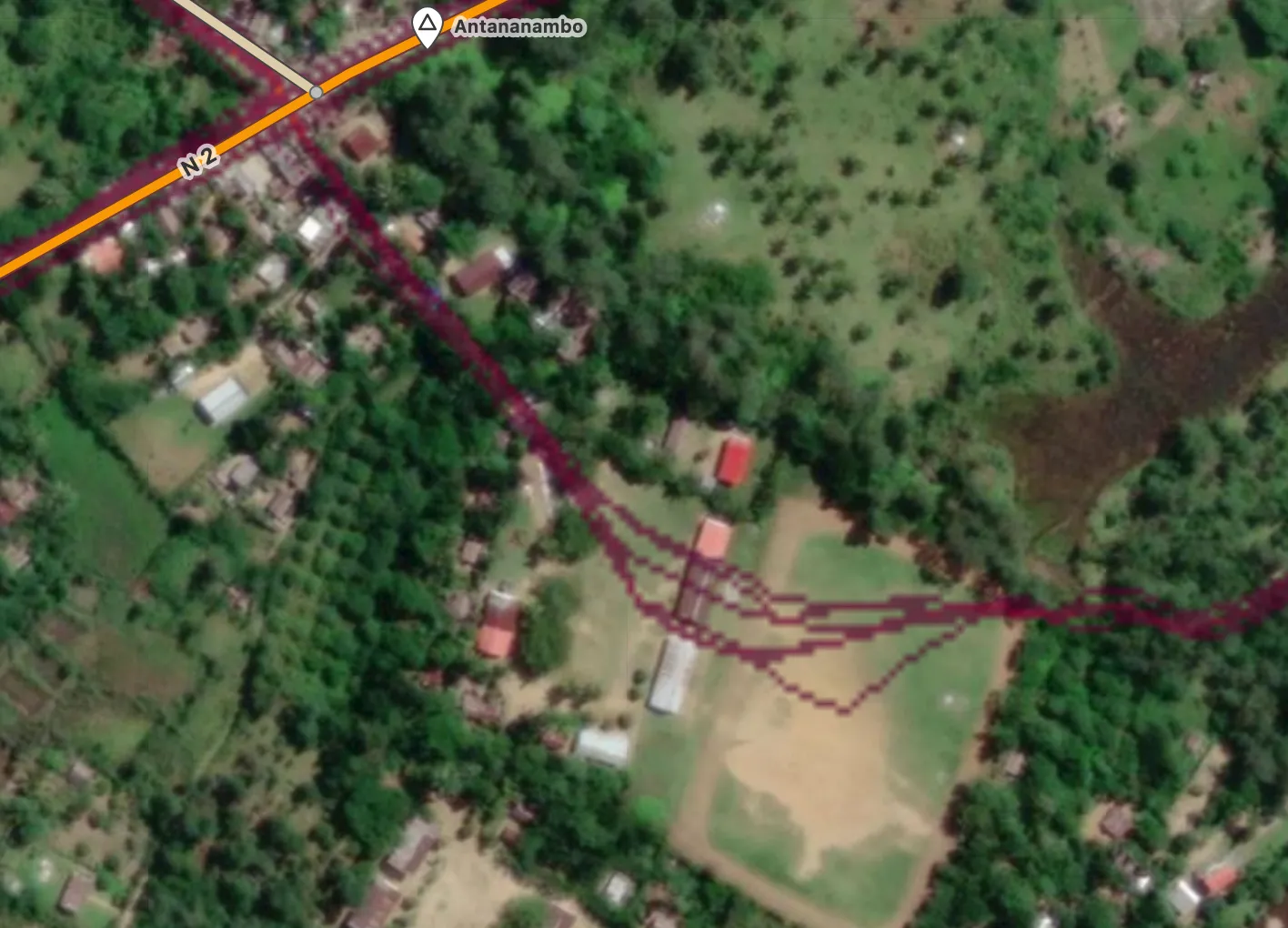 Remote area with a path through buildings and a field, shown via Strava heatmap